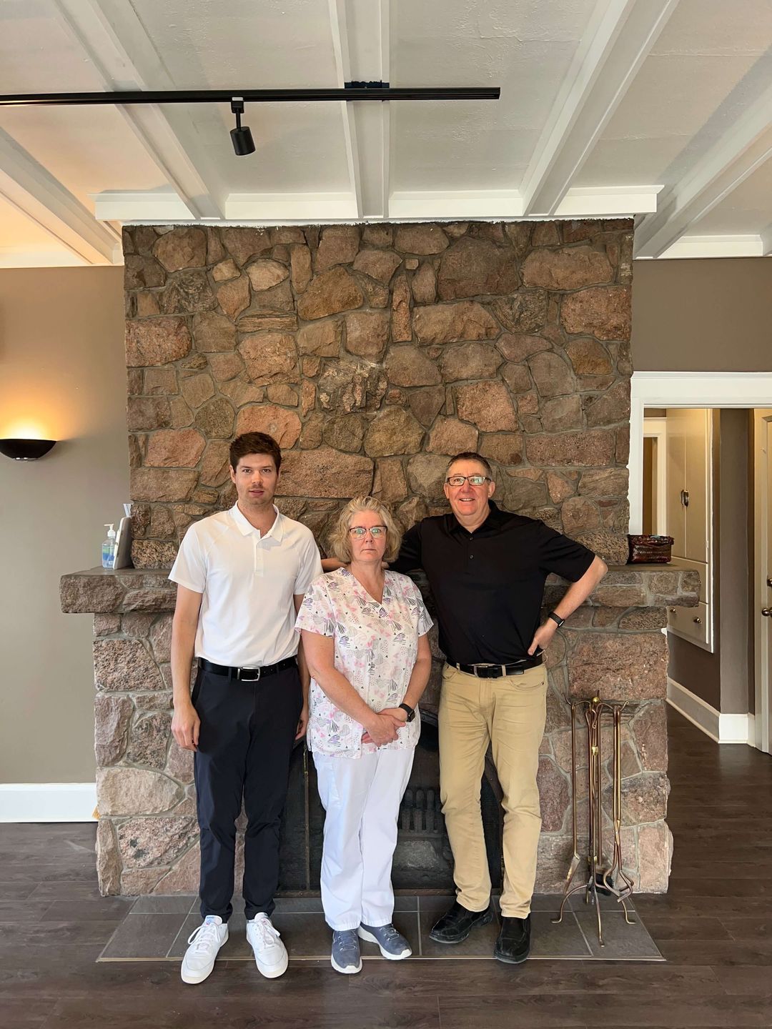 Kreze Denture Clinic team in front of the office fireplace